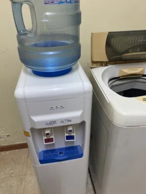 Oman Oasis hot and cold water dispenser with two empty bottles