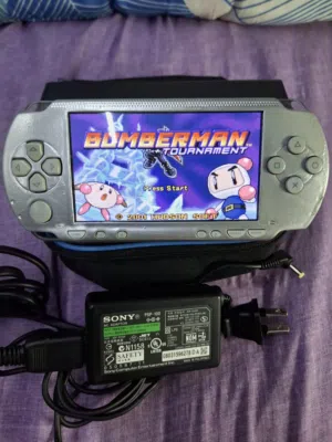 PSP SONY P1000 MODEL. GREY COLOR 2GB SD CARD 25 GAMES AVAILABLE