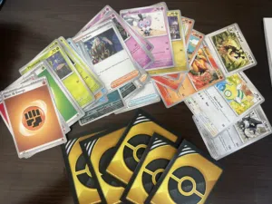 40 Assorted Pokemon Cards with 5 Gold Card Protection Sleeves