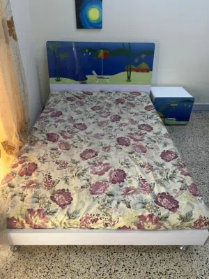 Single Bed with Beach-Themed Headboard and Matching Nightstand and desk