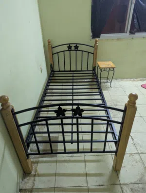 Single bed Hard metal and small table