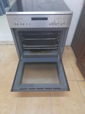 غاز كهربا مع فرن لون سلفر وموفر للكهربا