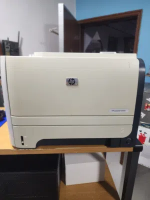 HP LaserJet P2055 Printer +Partially used toner installed in printer + 1 new toner cartridge CE505A