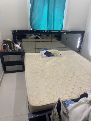 big bed with mattress and side table