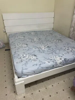 bed, paintings, office desk