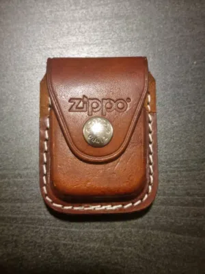 Zippo lighter with leather case for sale .