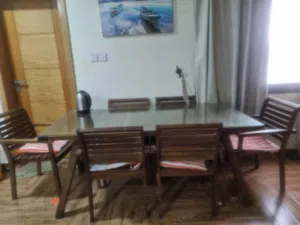 wooden dining table and 6 chair with glass protection in the top with good condition