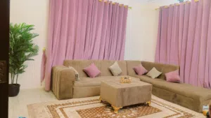 L-Shaped sofa bed with matching cushions, table and carpet