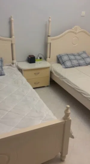 Two single beds with mattresses and bedside table (cream finish)