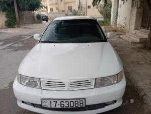 ميتسوبيشي لانسر 2000 صالون أبيض مرخصة ومجمركة مع أنوار نهارية وبلوتوث