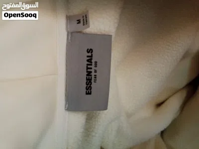 Based on the image provided, these are Fear of God Essentials cream/beige hoodies and a matching tra 4
