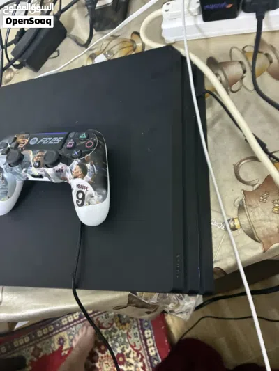 A barley used ps4 pro 1 terabyte 2 controllers and a charger 2