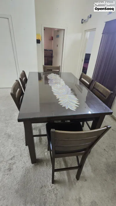 Dining table with 6 leather seated chairs. 2