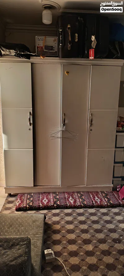 One big wodden cabinet white neat and clean. 2