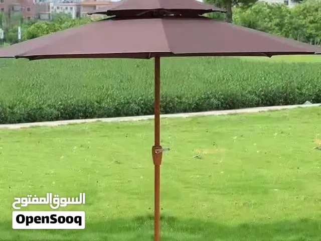 outdoor central column patio umbrella with a center pole and a white base.