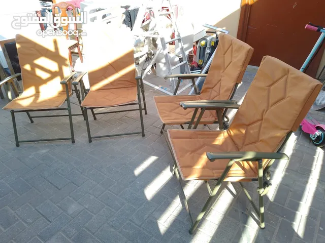 Four foldable outdoor chairs with a sturdy metal frame