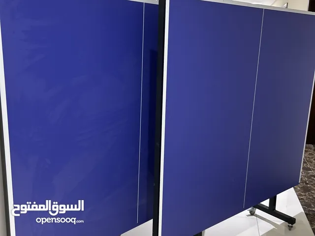 Ping pong table with rackets