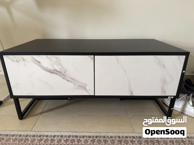 A white and black Tv Unit with drawers