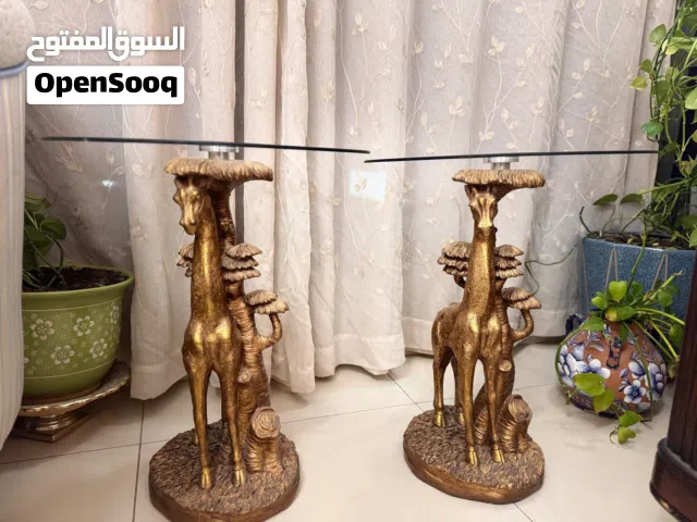 Two golden giraffe tables