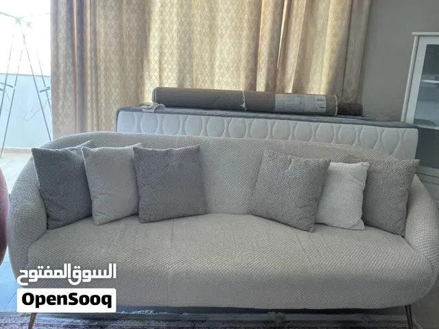 Big sofa and one single sofa with cushions