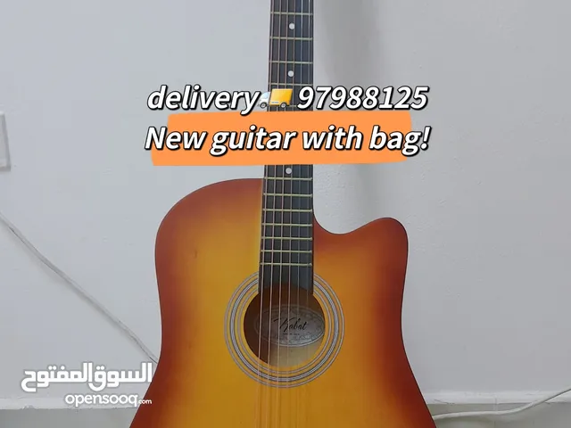 New acoustic guitar, with bag and picks, delivery