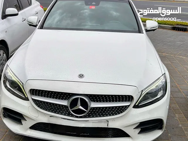 Mercedes Benz C200, white, excellent condition, under warranty and service contract.