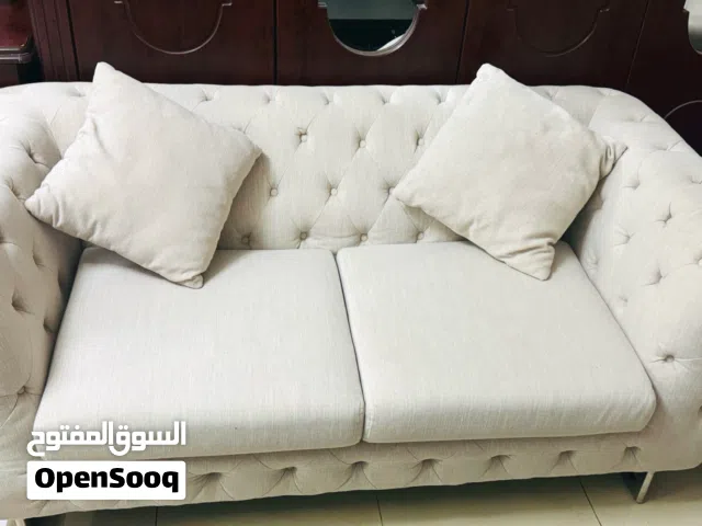 Elegant Beige Upholstered Sofa with Cushions