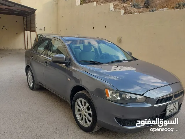 سيارة ميتسوبيشي لانسر 2011 أسمنتي مرخصة وبحالة جيدة مجهزة بكافة الخيارات