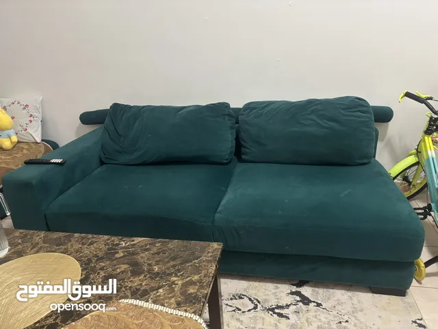 L-shaped fabric sofa (right side) in emerald colour