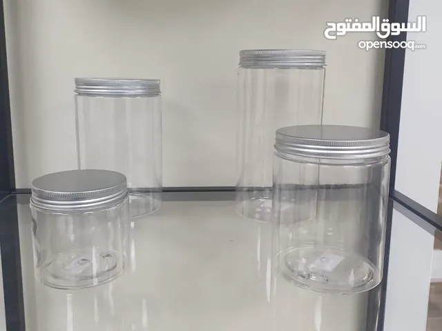 Clear plastic jars with white and silver lids