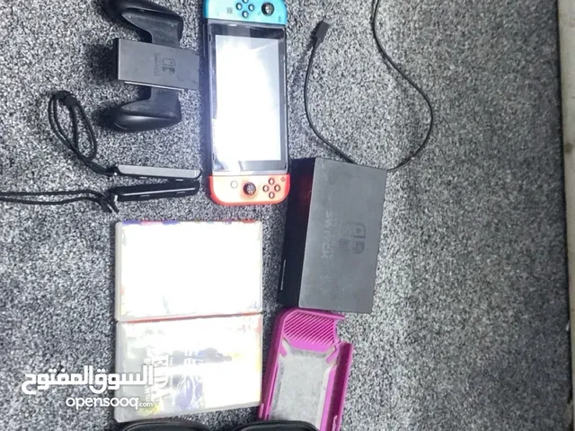Nintendo switch with games and accessories and with its case and travelling case