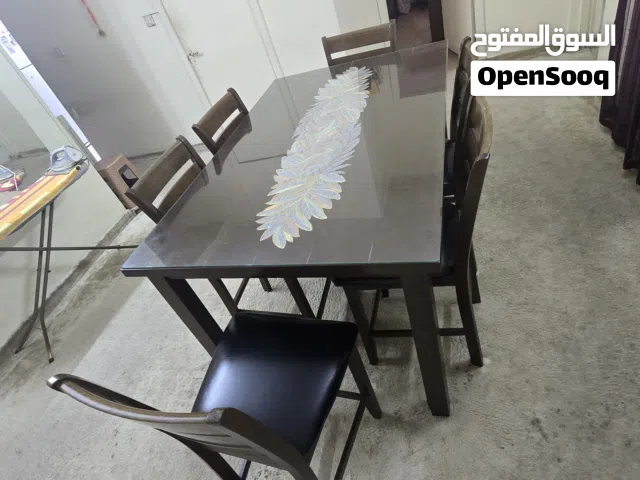 Dining table with 6 leather seated chairs.