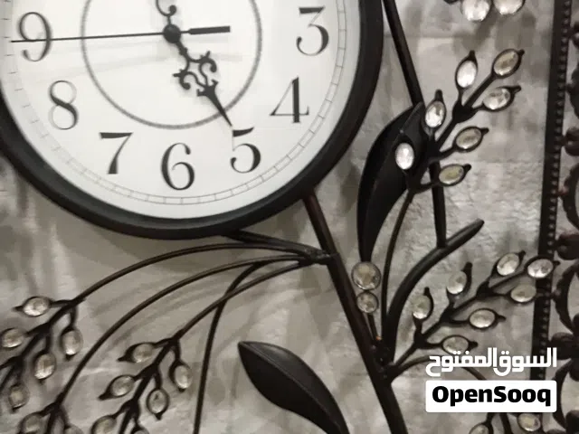 ساعه حائط معدنيه لون بني محروق