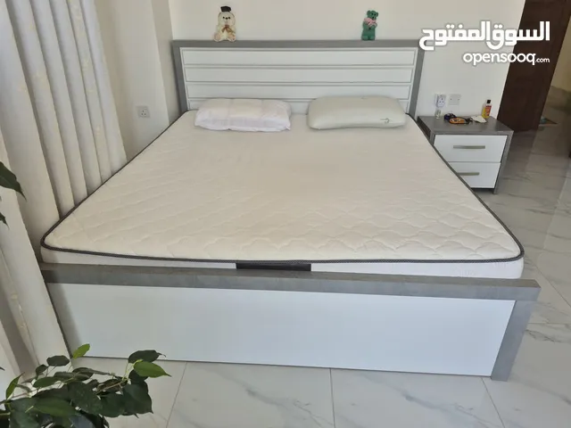 King size bed with orthopedic mattress and a night stand