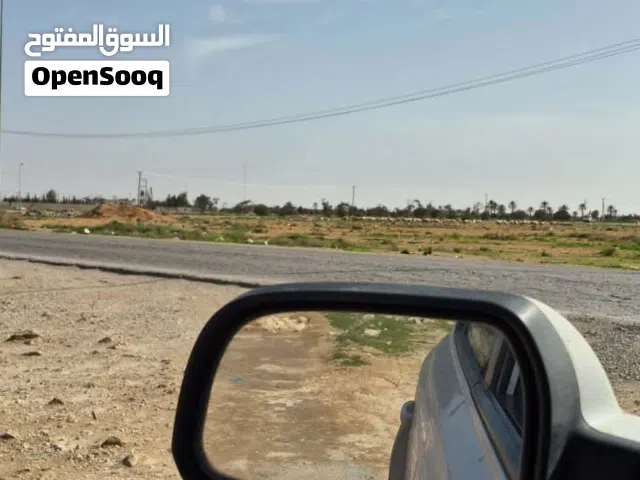 قطعة أرض في بودريسه نص هكتار علي شارعين قريب من رئيسي جنب سوبر ماركت الجود جيران محترمين
