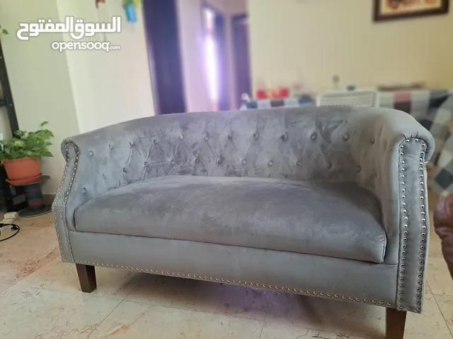 Two seater newly purchasec sofa and an excersice bicycle