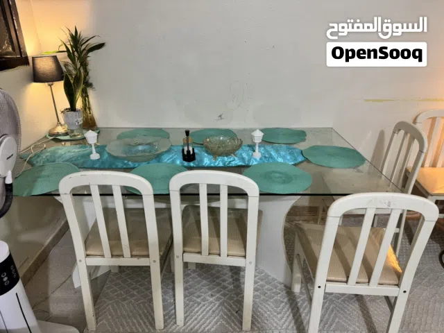 Glass top dinning table with eight chairs