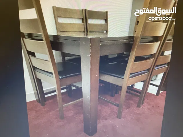 Brown wooden Dining table without chairs kept for urgent sale