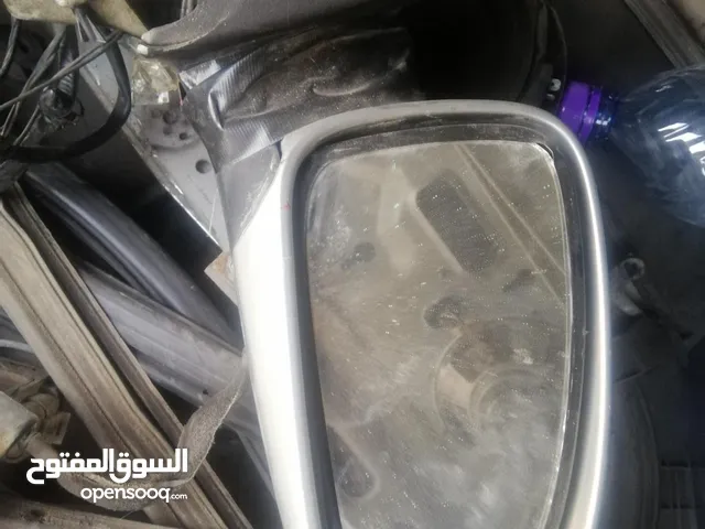 قطع شفر افيو 2005 / ماكينة زجاج باب السائق + بلف + مراية جنب جهة باب السائق