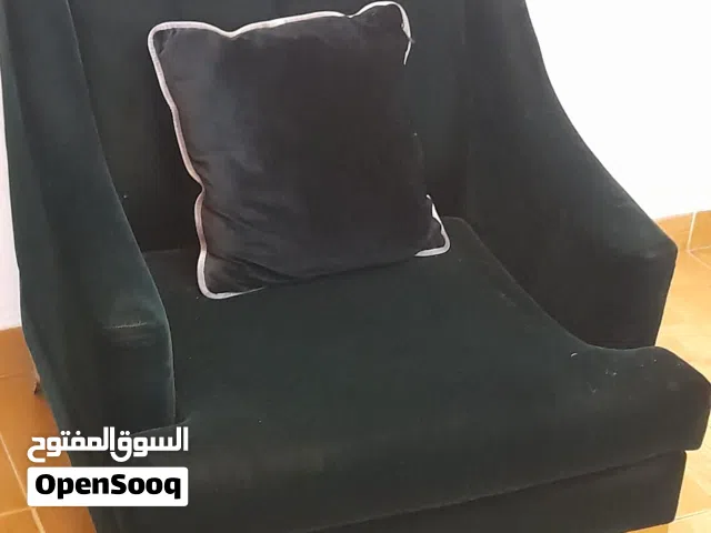 single seater sofa with green velvet fabric in good condition