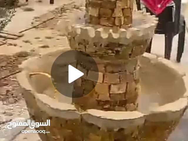 نوافير حديقه كبيره ملبسه حجر