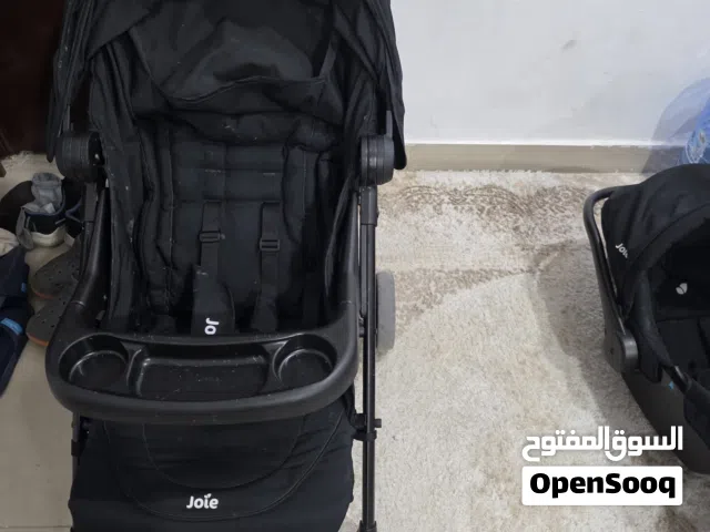 عربة أطفال و كرسي سيارة ملحق بها