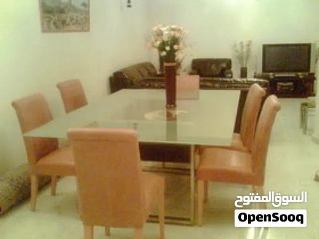 Huge glass top dining table with leather chairs