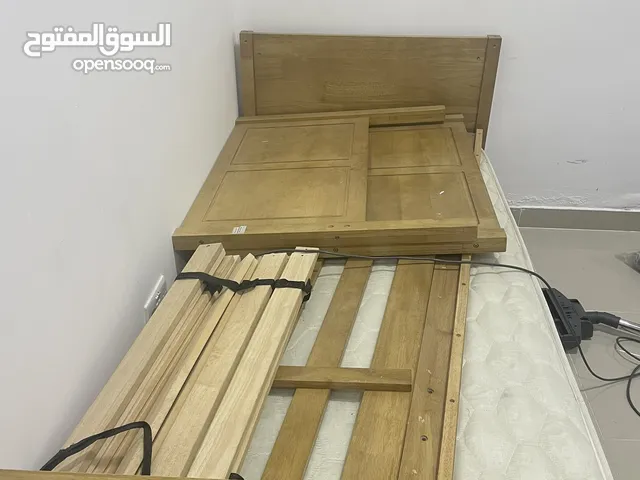 2 single beds made of wood