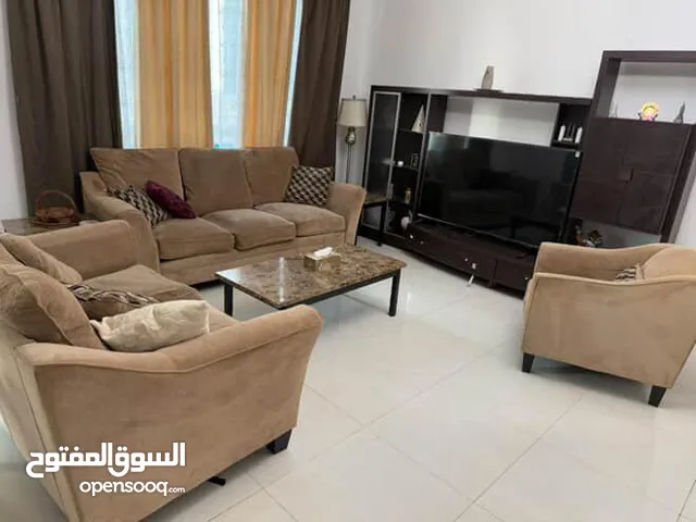 كنبات مع طاولات مع حامل تلفزيون