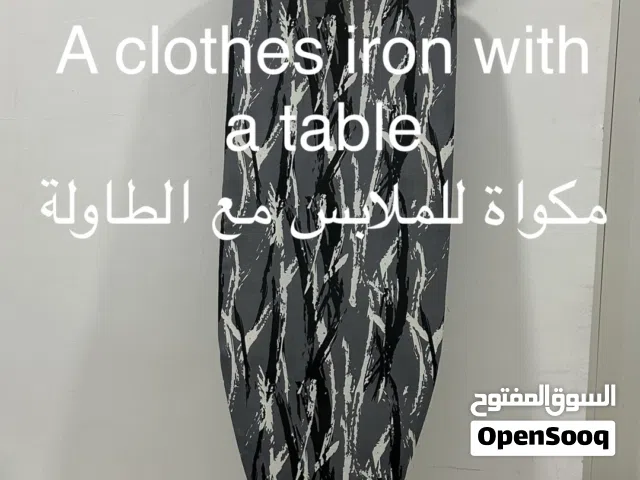 A clothes iron with a table مكواة للملابس مع الطاولة