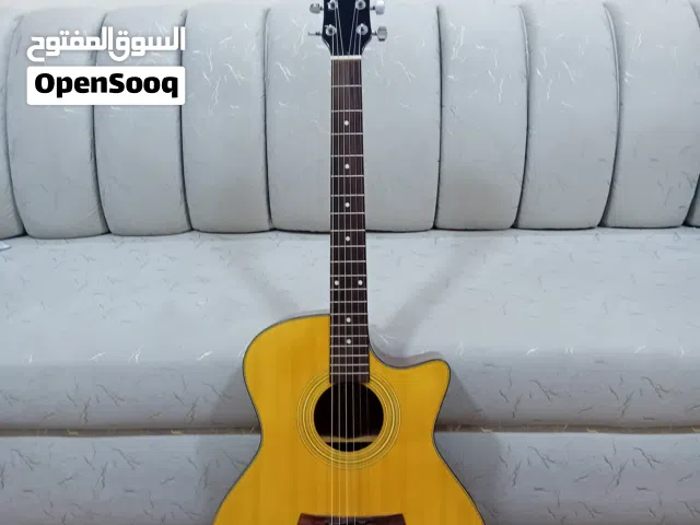 Acoustic guitar with bag and picks