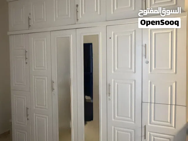 خزانة ملابس بيضاء كبيرة مع مرايتان ورفوف علوية