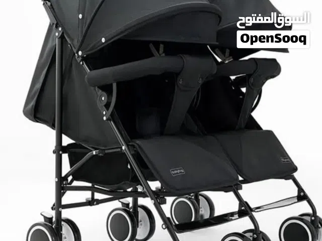 عربة أطفال توأم