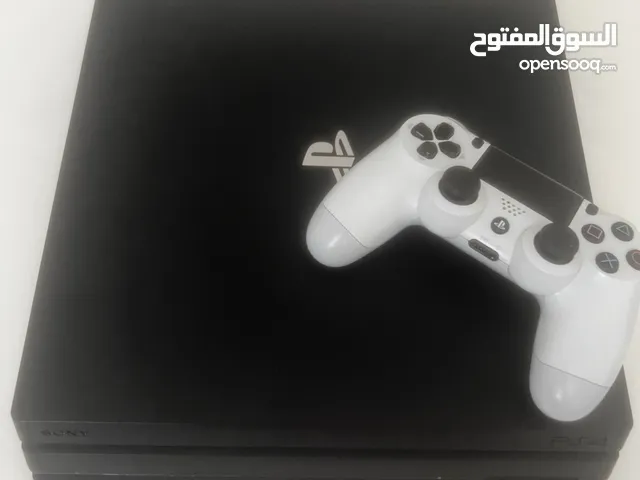 PlayStation 4 pro with white controller and crash bandicoot disc